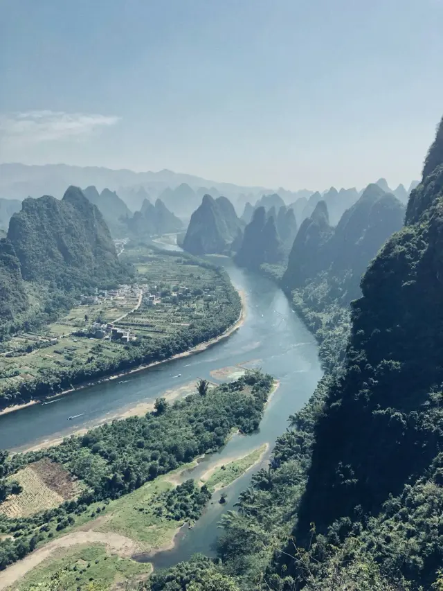 A peaceful river winding between Guilin's green hills